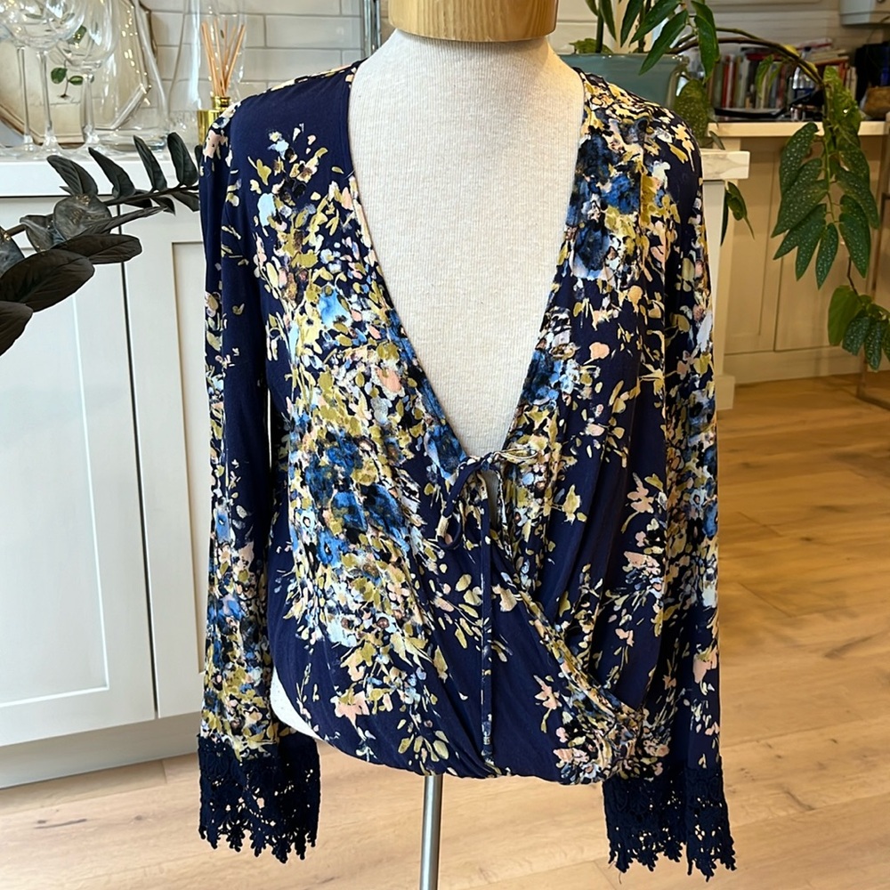 EUC dark blue floral print bell sleeve wrap style blouse from Lovestitch